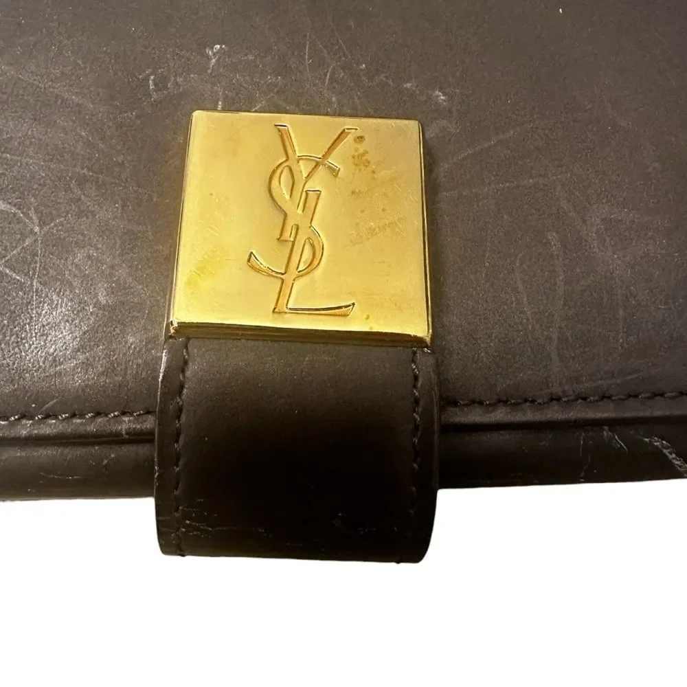 Yves Saint Laurent Tan Leather Wallet with Gold Clasp with marks and scratches.